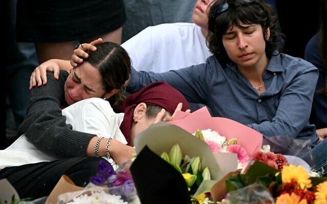 Family members of victims at a memorial for victims of the Hanukkah terror attack at Bondi Beach, in Sydney on December 16, 2025 (Saeed KHAN / AFP)