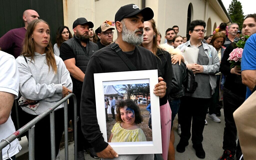 A family member holds a portrait of ten-year-old Matilda, killed in the terror attack targeting a Hanukkah event at the Bondi Pavilion in Sydney on December 16, 2025v(Saeed KHAN / AFP)