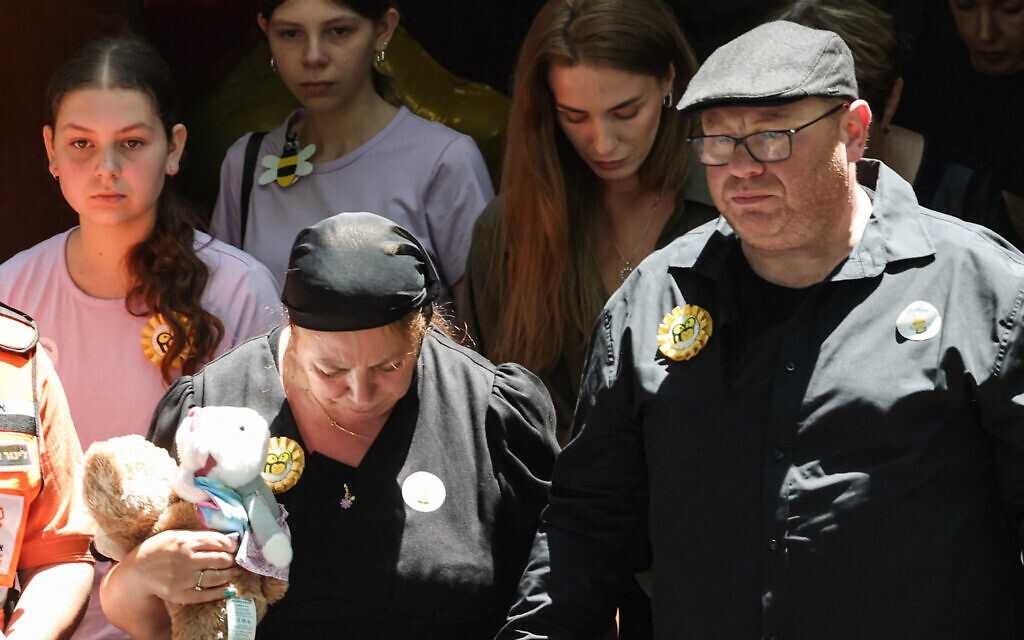 The parents of 10-year-old Matilda, who was killed in the Bondi Beach terror attack, follow behind their daughter's coffin after the funeral service in Sydney on December 18, 2025. (David Gray/AFP)