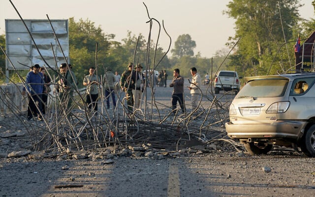 People look at a damaged bridge after Thailand carried out air strikes in an area between Cambodia's Oddar Meanchey and Siem Reap provinces on December 20, 2025. (AFP) People look at a damaged bridge after Thailand carried out air strikes in an area between Cambodia's Oddar Meanchey and Siem Reap provinces on December 20, 2025. (AFP)