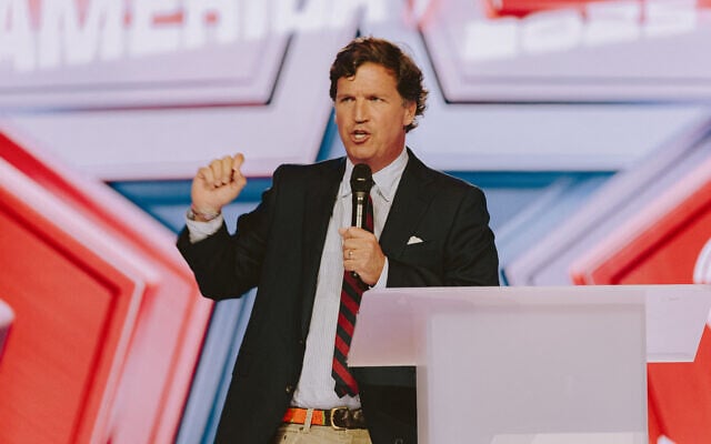 Conservative political commentator and podcast host Tucker Carlson speaks at Turning Point's annual AmericaFest conference, in remembrance of late right-wing political activist Charlie Kirk, in Phoenix, Arizona, December 18, 2025. (Olivier Touron / AFP) Conservative political commentator and podcast host Tucker Carlson speaks at Turning Point's annual AmericaFest conference, in remembrance of late right-wing political activist Charlie Kirk, in Phoenix, Arizona, December 18, 2025. (Olivier Touron / AFP)