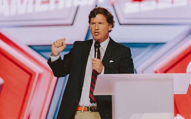 Conservative political commentator and podcast host Tucker Carlson speaks at Turning Point USA's annual AmericaFest conference, in remembrance of late right-wing political activist Charlie Kirk, in Phoenix, Arizona, December 18, 2025. (Olivier Touron / AFP) Conservative political commentator and podcast host Tucker Carlson speaks at Turning Point USA's annual AmericaFest conference, in remembrance of late right-wing political activist Charlie Kirk, in Phoenix, Arizona, December 18, 2025. (Olivier Touron / AFP)