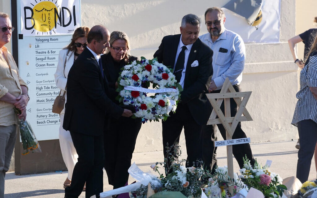 Officials from the Australian-Turkish community lay a wreath as mourners gather in front of tributes in memory of victims of a shooting at Bondi Beach, in Sydney on December 20, 2025. (DAVID GRAY / AFP) Officials from the Australian-Turkish community lay a wreath as mourners gather in front of tributes in memory of victims of a shooting at Bondi Beach, in Sydney on December 20, 2025. (DAVID GRAY / AFP)