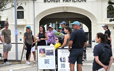 Mourners visit the site of a memorial outside the Bondi Pavilion after the clean-up of floral tributes following seven days of mourning, a week after the Bondi Beach terror attack targeting a Hanukkah event, in Sydney on December 22, 2025. (Saeed KHAN / AFP)