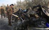 A Lebanese soldier inspects the wreckage of a car that was targeted in an Israeli air strike near the southern Lebanese village of Mazraat al Qnaitra on December 22, 2025. (Mahmoud Zayyat/AFP)