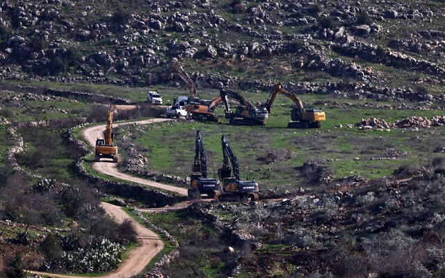Israeli bulldozers break ground for the construction of settlements in the Sarouj area, located between the towns of Silat al-Harithiya and Yamoun, west of Jenin in the West Bank, on December 22, 2025. (Zain Jaafar/AFP)