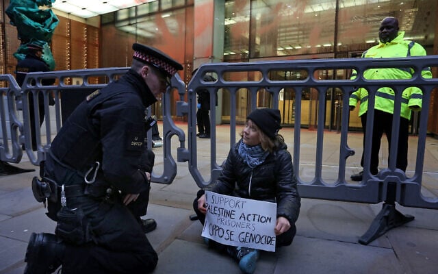 A handout photograph released by Prisoners for Palestine in London on December 23, 2025, shows Swedish activist Greta Thunberg before her arrest by police officers outside the offices of Aspen Insurance at Plantation Place at a protest in support of Palestine Action hunger strikers. (AFP/Prisoners for Palestine/Handout) A handout photograph released by Prisoners for Palestine in London on December 23, 2025, shows Swedish activist Greta Thunberg before her arrest by police officers outside the offices of Aspen Insurance at Plantation Place at a protest in support of Palestine Action hunger strikers. (AFP/Prisoners for Palestine/Handout)