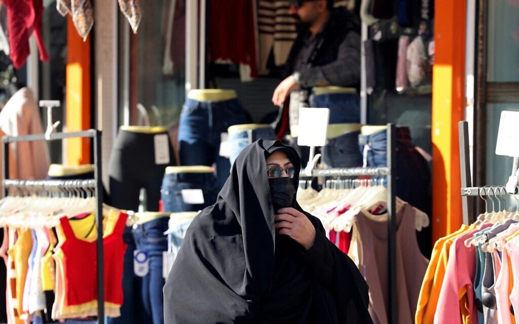 Iranians walks past shops in Vali-Asr Square in the Iranian capital Tehran, on December 31, 2025 (ATTA KENARE / AFP)