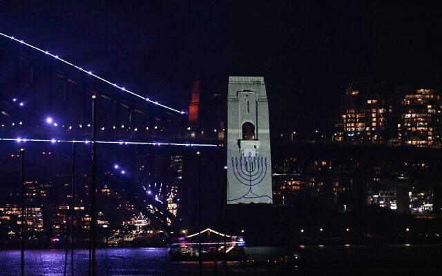 The figure of a menorah is displayed on the pylon of the Sydney Harbour Bridge to reflect on the tragic Bondi Beach shooting attack before a New Year's Eve midnight fireworks display in Sydney on December 31, 2025. (Saeed KHAN / AFP)