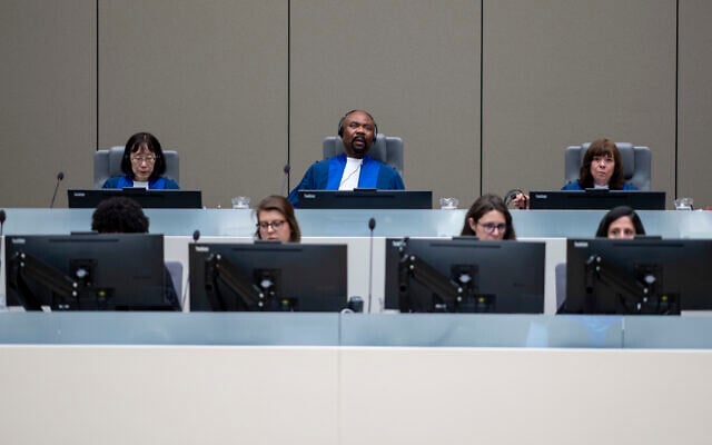 Presiding judge Antoine Kesia-Mbe Mindua, center, Judge Tomoko Akane, left, and Judge Kimberly Prost, right, prepare to deliver the verdict in a case at the International Criminal Court in The Hague, Netherlands, Wednesday, June 26, 2024. (AP Photo/Peter Dejong, Pool)