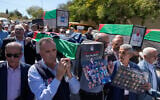 Palestinian journalists carry posters and mock coffins with pictures of their colleagues who were killed during the war in Gaza and read "stop the media genocide, journalism is not a crime," during a symbolic funeral to commemorate the second anniversary of the war in Gaza, in front of the United Nations office, in the West Bank city of Ramallah, October 8, 2025. (AP Photo/Nasser Nasser)