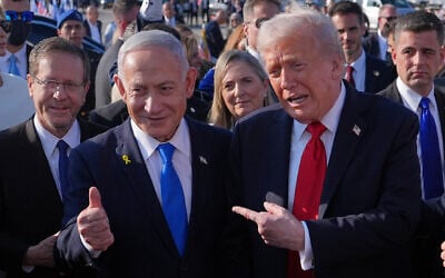 US President Donald Trump (right) poses for a photo with Prime Minister Benjamin Netanyahu before he boards Air Force One at Ben Gurion International Airport, October 13, 2025, near Tel Aviv, as President Isaac Herzog (left) watches. (AP/Evan Vucci)