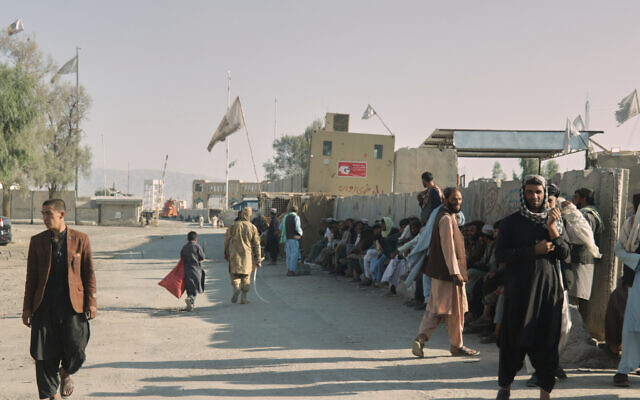 People wait near the closed gate at the Spin Boldak border crossing with Pakistan, after the border was shut for nearly two weeks following clashes between Afghan and Pakistani forces, in Kandahar province, Afghanistan, October 23, 2025. (AP Photo/Sibghatullah) People wait near the closed gate at the Spin Boldak border crossing with Pakistan, after the border was shut for nearly two weeks following clashes between Afghan and Pakistani forces, in Kandahar province, Afghanistan, October 23, 2025. (AP Photo/Sibghatullah)