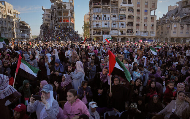 Palestinian watch and celebrate a mass wedding ceremony in Hamad City in Khan Younis, Gaza Strip, Tuesday, Dec. 2, 2025. (AP Photo/Abdel Kareem Hana)