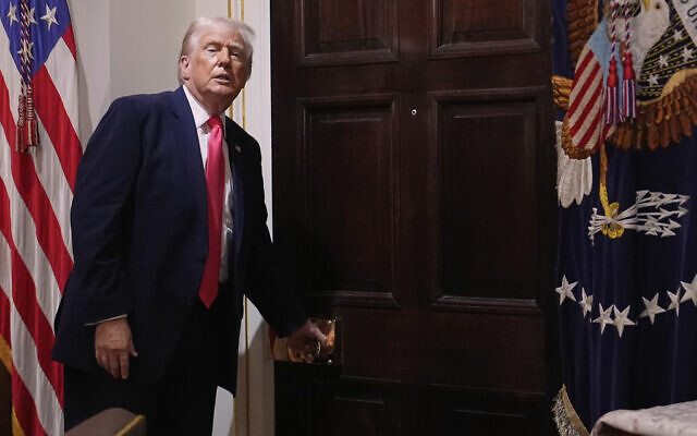 US President Donald Trump walks out of the Cabinet Room following a cabinet meeting at the White House, December 2, 2025, in Washington. (AP Photo/Julia Demaree Nikhinson)