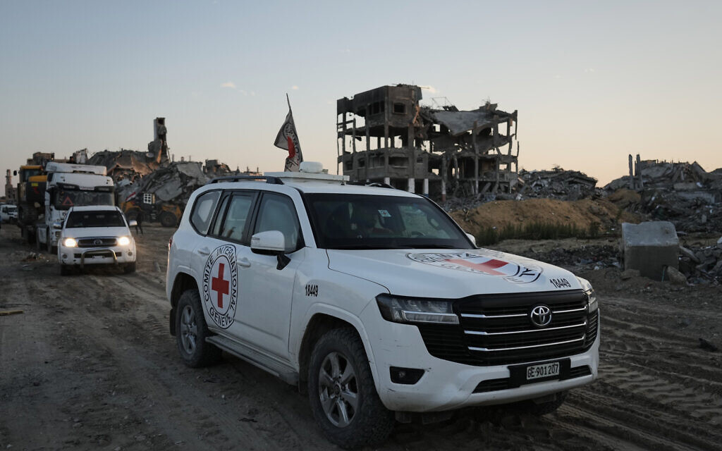 A Red Cross vehicle, carrying what are believed to be the remains of a deceased hostage handed over by Hamas operatives, heads toward the border crossing with Israel for transfer to Israeli troops,in the northern Gaza Strip, December 3, 2025. (AP Photo/Jehad Alshrafi)