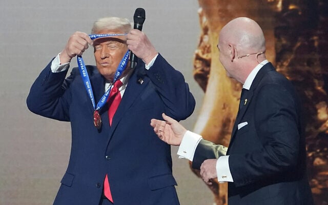 US President Donald Trump, left, is presented with the inaugural FIFA Peace Prize by FIFA President Gianni Infantino during the 2026 FIFA World Cup draw at the Kennedy Center in Washington, December 5, 2025. (AP Photo/Evan Vucci) US President Donald Trump, left, is presented with the inaugural FIFA Peace Prize by FIFA President Gianni Infantino during the 2026 FIFA World Cup draw at the Kennedy Center in Washington, December 5, 2025. (AP Photo/Evan Vucci)