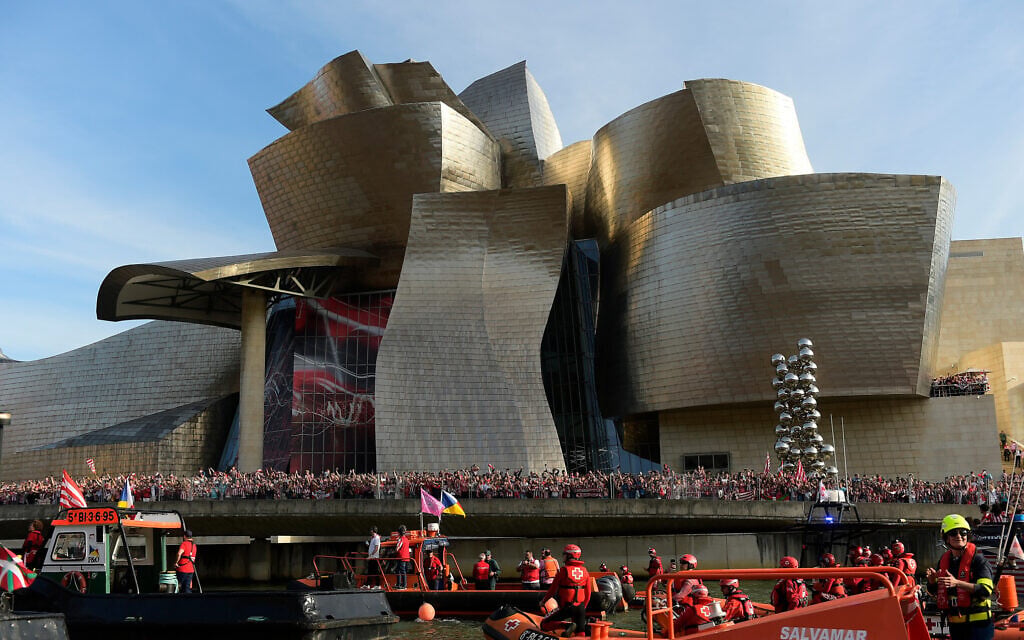 Athletic Bilbao fans wait in front of the Guggenheim museum as support boats pass before team celebrations on the Nervion Estuary in Bilbao, Spain, April 11, 2024. (AP Photo/Alvaro Barrientos, File)