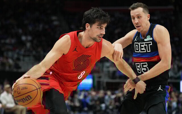 Portland Trail Blazers forward Deni Avdija (left) drives against Detroit Pistons forward Duncan Robinson during the first half of an NBA basketball game in Detroit, December 5, 2025. (AP Photo/Ryan Sun)
