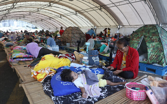 Thai residents who fled homes as Thailand and Cambodia clash over border, rest at an evacuation center in Buriram province, Thailand, December 8, 2025. (AP Photo/ Sopa Saelee)