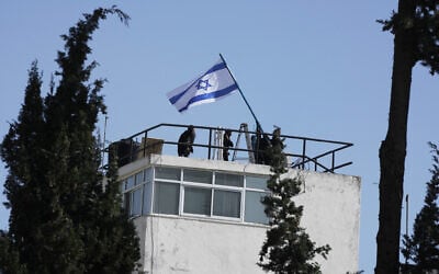 Israeli police and officials hang an Israeli flag on the UNRWA compound in East Jerusalem, December 8, 2025. (AP Photo/Mahmoud Illean) Israeli police and officials hang an Israeli flag on the UNRWA compound in East Jerusalem, December 8, 2025. (AP Photo/Mahmoud Illean)