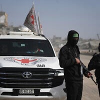 Hamas gunmen accompanied by members of the International Committee of the Red Cross (ICRC) head to the Zeitoun neighborhood of Gaza City to search for the remains of deceased hostages, December 8, 2025. (Jehad Alshrafi/AP)