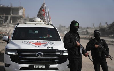 Hamas gunmen accompanied by members of the International Committee of the Red Cross (ICRC) head to the Zeitoun neighborhood of Gaza City to search for the remains of deceased hostages, December 8, 2025. (Jehad Alshrafi/AP)