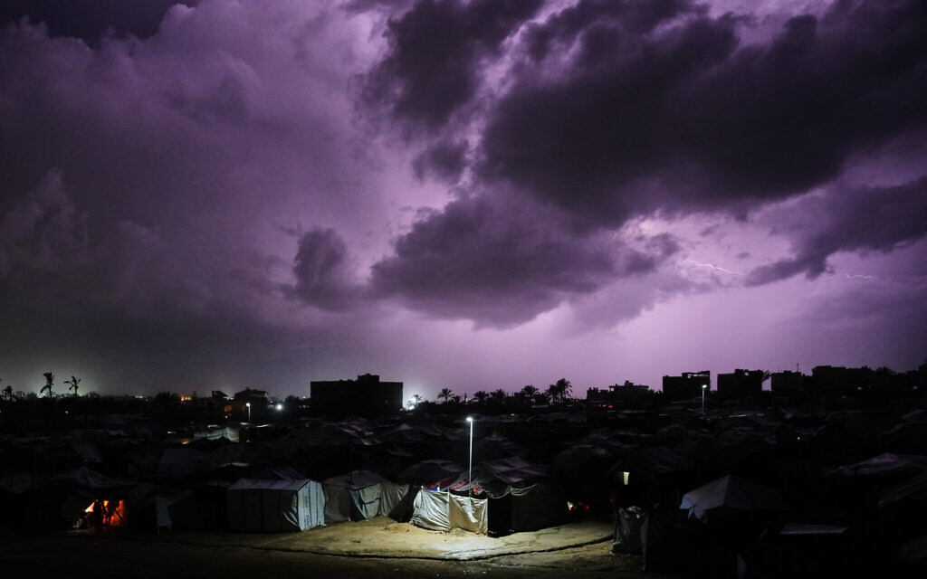A thunderstorm is seen over a tent camp for displaced Palestinians in Zawayda, central Gaza Strip, December 10, 2025. (AP/Abdel Kareem Hana) A thunderstorm is seen over a tent camp for displaced Palestinians in Zawayda, central Gaza Strip, December 10, 2025. (AP/Abdel Kareem Hana)