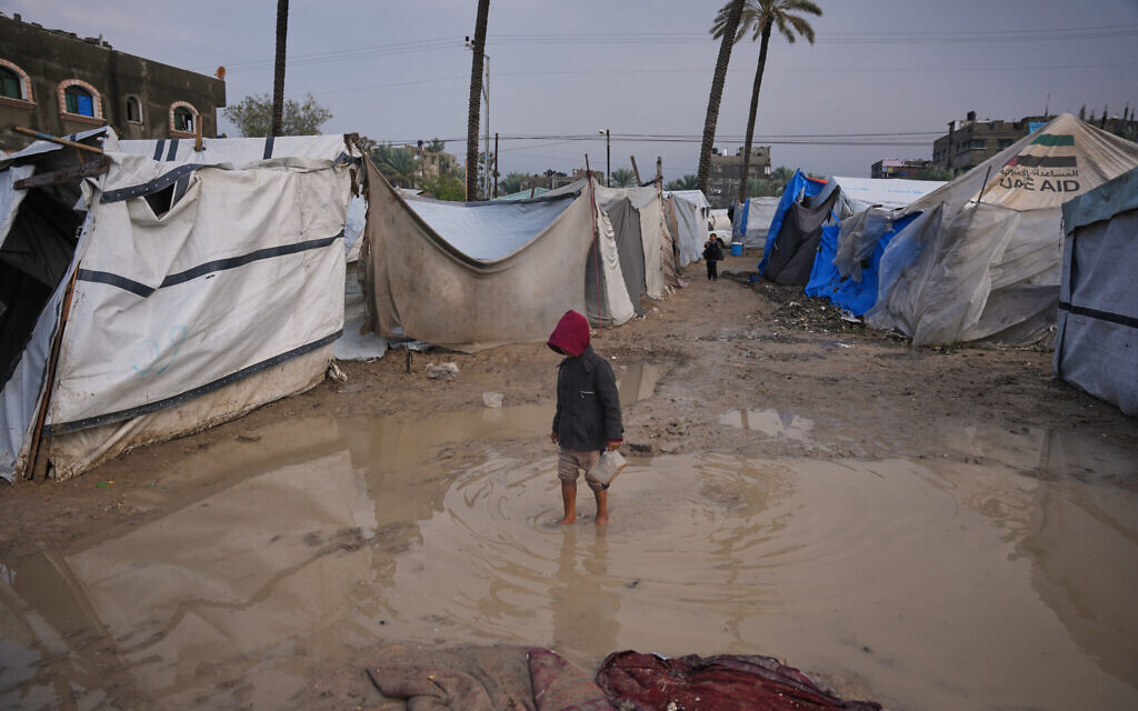 A Palestinian boy walks through water in a temporary tent camp after heavy rainfall in Deir el-Balah, in the centra Gaza Strip, December 12, 2025. (AP Photo/Abdel Kareem Hana) A Palestinian boy walks through water in a temporary tent camp after heavy rainfall in Deir el-Balah, in the centra Gaza Strip, December 12, 2025. (AP Photo/Abdel Kareem Hana)