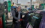 A man fills his car at a gas station in Tehran, Iran, December 13, 2025. (AP Photo/Vahid Salemi)