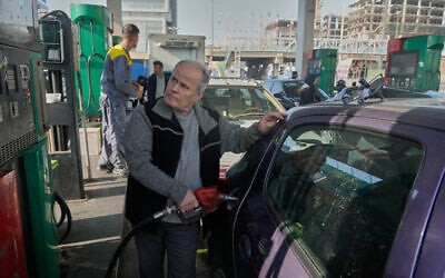 A man fills his car at a gas station in Tehran, Iran, December 13, 2025. (AP Photo/Vahid Salemi)