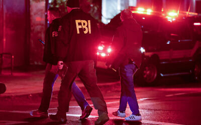 FBI personnel gather near Brown University in Providence, Rhode Island, on December 13, 2025, during the investigation of a shooting. (AP/Mark Stockwell)