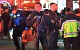 Law enforcement officials carrying weapons gather near Brown University in Providence, Rhode Island, December 13, 2025, during the investigation of a shooting. (AP Photo/Steven Senne)