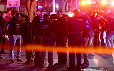 Police gather on Waterman Street in Providence, Rhode Island, on December 13, 2025, during the investigation of a mass shooting. (AP/Mark Stockwell)