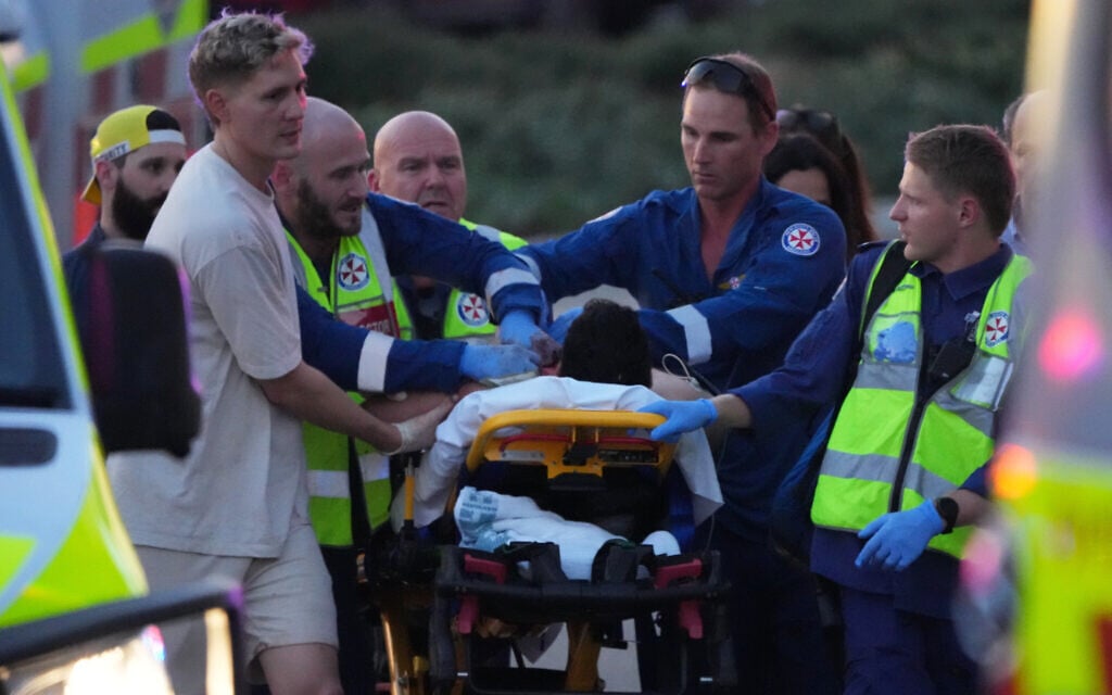 A person on a stretcher after a deadly terror shooting at a Hanukkah event at Bondi Beach in Sydney, December 14, 2025. (AP/Mark Baker) A person on a stretcher after a deadly terror shooting at a Hanukkah event at Bondi Beach in Sydney, December 14, 2025. (AP/Mark Baker)