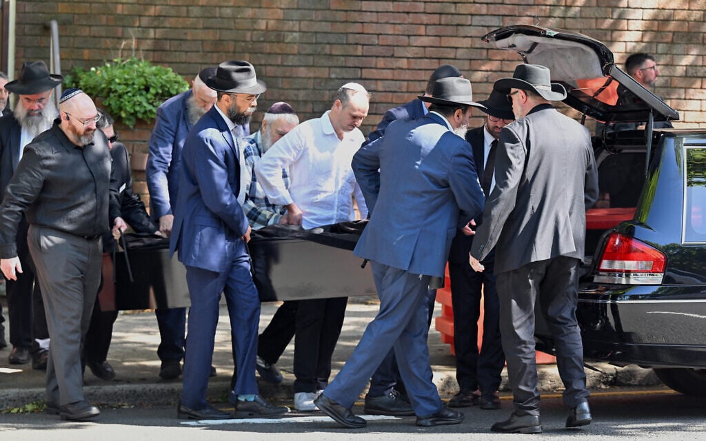 The casket of Holocaust survivor and Bondi shooting victim Alex Kleytman is carried out during the funeral at Chevra Kadisha in Sydney, December 18, 2025 (Dean Lewins/AAP Image via AP)