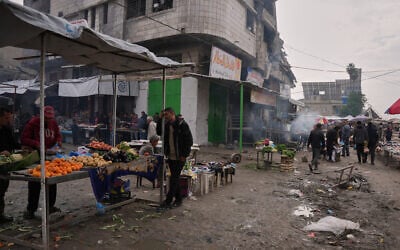Palestinians walk along street market where fruits and vegetables are displayed for sale in Gaza City, Friday, Dec. 19, 2025. (AP Photo/Abdel Kareem Hana) Palestinians walk along street market where fruits and vegetables are displayed for sale in Gaza City, Friday, Dec. 19, 2025. (AP Photo/Abdel Kareem Hana)