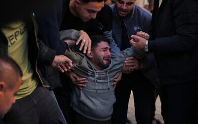 Mohammed al-Neder, 21, mourns over the bodies of members of his family, who were reportedly killed by Israeli fire on a school-turned-shelter in the Tuffah neighborhood of Gaza City, December 20, 2025. (AP/Abdel Kareem Hana) Mohammed al-Neder, 21, mourns over the bodies of members of his family, who were reportedly killed by Israeli fire on a school-turned-shelter in the Tuffah neighborhood of Gaza City, December 20, 2025. (AP/Abdel Kareem Hana)