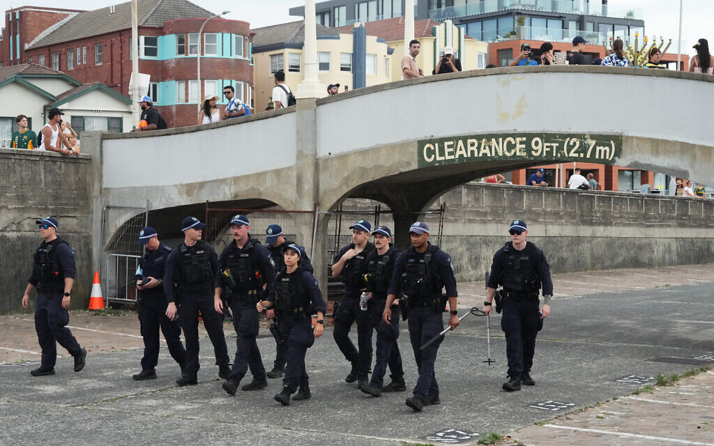Security officers sweep an area at Bondi Beach in Sydney, December 21, 2025, ahead of a ceremony to mark the National Day of Reflection for victims and survivors from the Bondi Beach deadly terror shooting targeting a Jewish event one week earlier. (AP/Mark Baker)