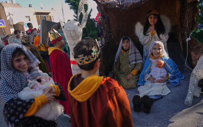 Wearing traditional costumes, children take part in the 40th annual Christmas parade heading toward the Basilica of the Annunciation in Nazareth, Israel, December 24, 2025. (AP Photo/Ariel Schalit)