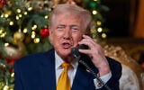 US President Donald Trump speaks on the phone during a North American Aerospace Defense Command (NORAD) Tracks Santa Operation call at his Mar-a-Lago club, Palm Beach, Florida, December 24, 2025. (AP/Alex Brandon)