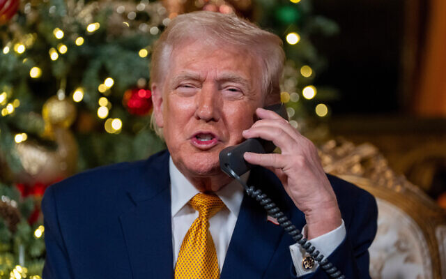 US President Donald Trump speaks on the phone during a North American Aerospace Defense Command (NORAD) Tracks Santa Operation call at his Mar-a-Lago club, Palm Beach, Florida, December 24, 2025. (AP/Alex Brandon) US President Donald Trump speaks on the phone during a North American Aerospace Defense Command (NORAD) Tracks Santa Operation call at his Mar-a-Lago club, Palm Beach, Florida, December 24, 2025. (AP/Alex Brandon)