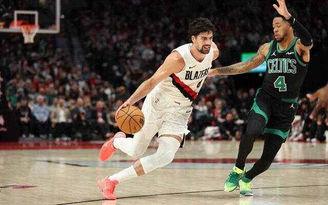 Portland Trail Blazers forward Deni Avdija drives to the ball as Boston Celtics guard Anfernee Simons (4) defends during the second half of an NBA basketball game, December 28, 2025, in Portland, Oregon. (AP Photo/Amanda Loman) Portland Trail Blazers forward Deni Avdija drives to the ball as Boston Celtics guard Anfernee Simons (4) defends during the second half of an NBA basketball game, December 28, 2025, in Portland, Oregon. (AP Photo/Amanda Loman)