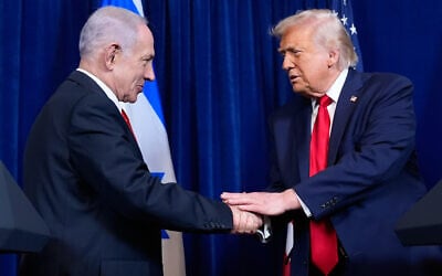 US President Donald Trump, right, shakes hands with Prime Minister Benjamin Netanyahu during a news conference at Mar-a-Lago, on December 29, 2025, in Palm Beach, Florida. (AP Photo/Alex Brandon)