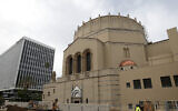 In this Jan. 23, 2013, photo, a construction worker walks past Wilshire Boulevard Temple in Los Angeles. (AP Photo/Jae C. Hong)