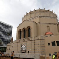 In this Jan. 23, 2013, photo, a construction worker walks past Wilshire Boulevard Temple in Los Angeles. (AP Photo/Jae C. Hong)