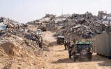 IDF soldiers stand near the entrance to a tunnel (right) in the Rafah area of the southern Gaza Strip, where the body of Lt. Hadar Goldin was held, December 8, 2025. (Emanuel Fabian/Times of Israel)