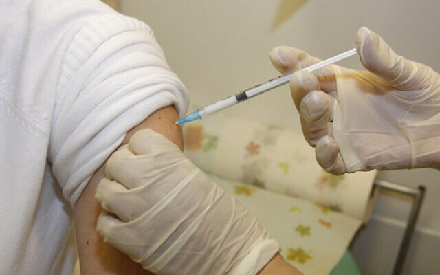 Illustrative: A patient is vaccinated at a health clinic in Jerusalem. (Miriam Alster/FLASH90) Illustrative: A patient is vaccinated at a health clinic in Jerusalem. (Miriam Alster/FLASH90)