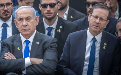 Prime Minister Benjamin Netanyahu, left, and President Isaac Herzog at a state memorial ceremony for victims of terror, at Mount Herzl military cemetery in Jerusalem, May 13, 2024 (Chaim Goldberg/Flash90)