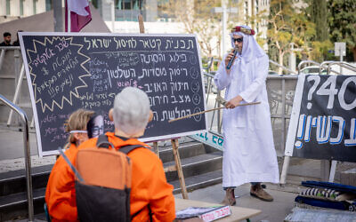 Israelis dressed as a Qatari emir,  Prime Minister Benjamin Netanyahu, and his aides put on a protest performance outside the District Court in Tel Aviv on March 31, 2025. (Miriam Alster/Flash90)